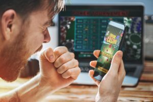 man winning online casino game while on mobile phone