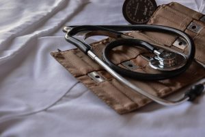 medical white sheet with stethoscope and blood pressure monitor